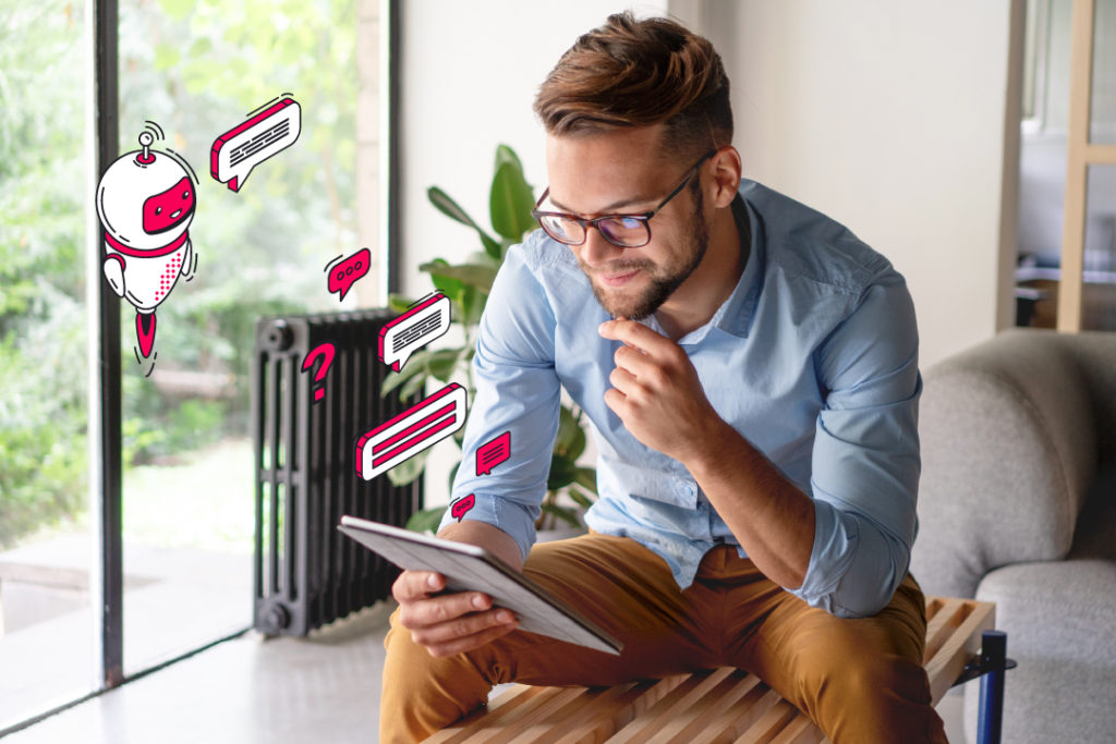 man wearing glasses sitting down and thinking whilst using tablet, chatbot and speech bubble Connect red illustrations are projected from the tablet